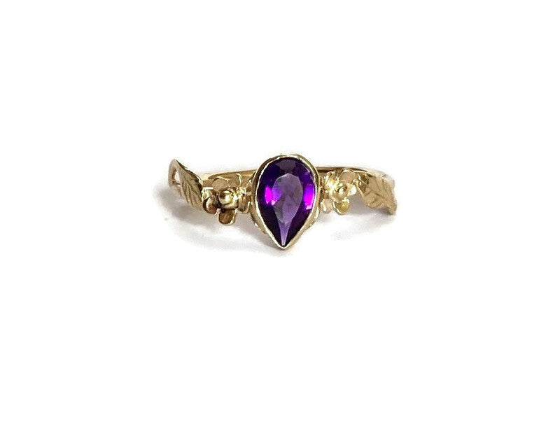pear shape dark amethyst gold floral ring, alternative engagement ring by Kim Styles Jewellery, on white background