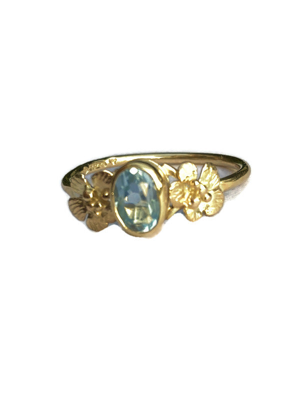 yellow gold ring floral ring set with pale blue gemstone
