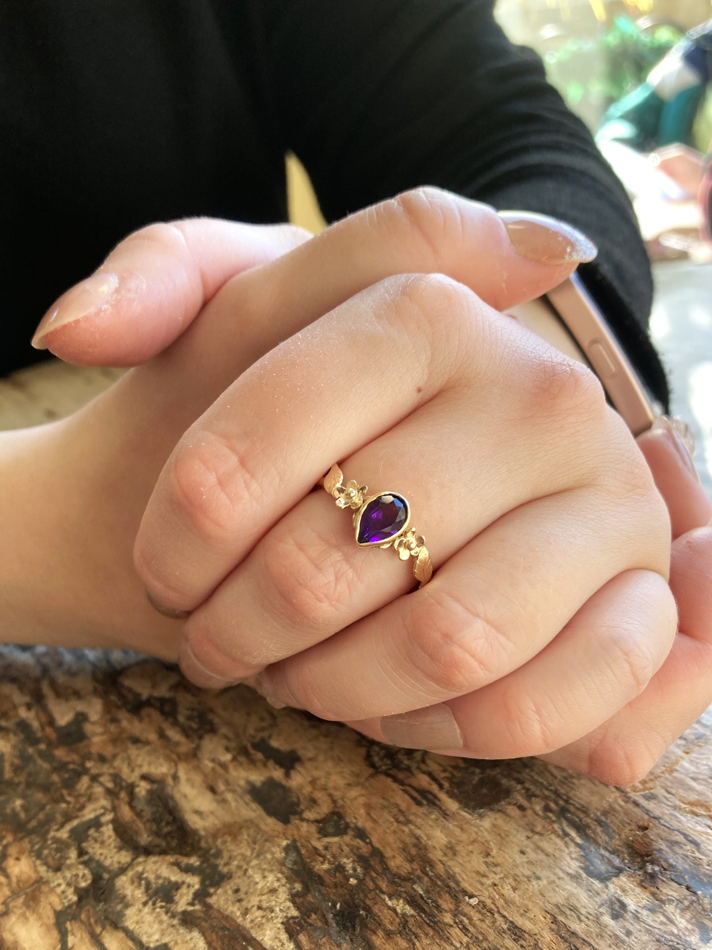 gold floral ring set with pear shape amethyst, on hands