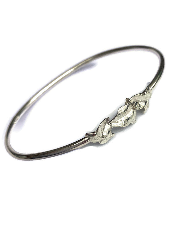 slim silver bangle with three dainty ivy leaves, on white background