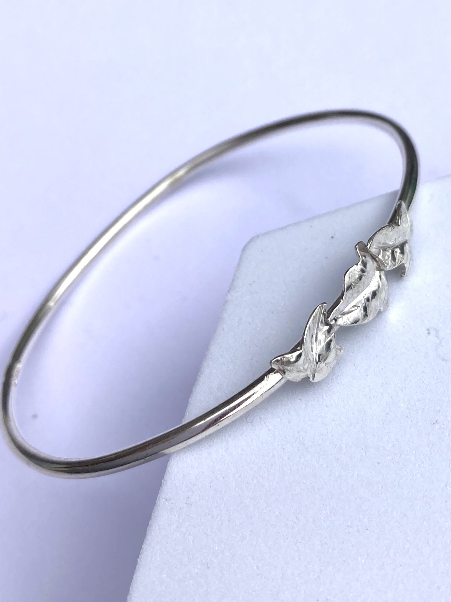 pretty dainty ivy leaf bangle on grey background
