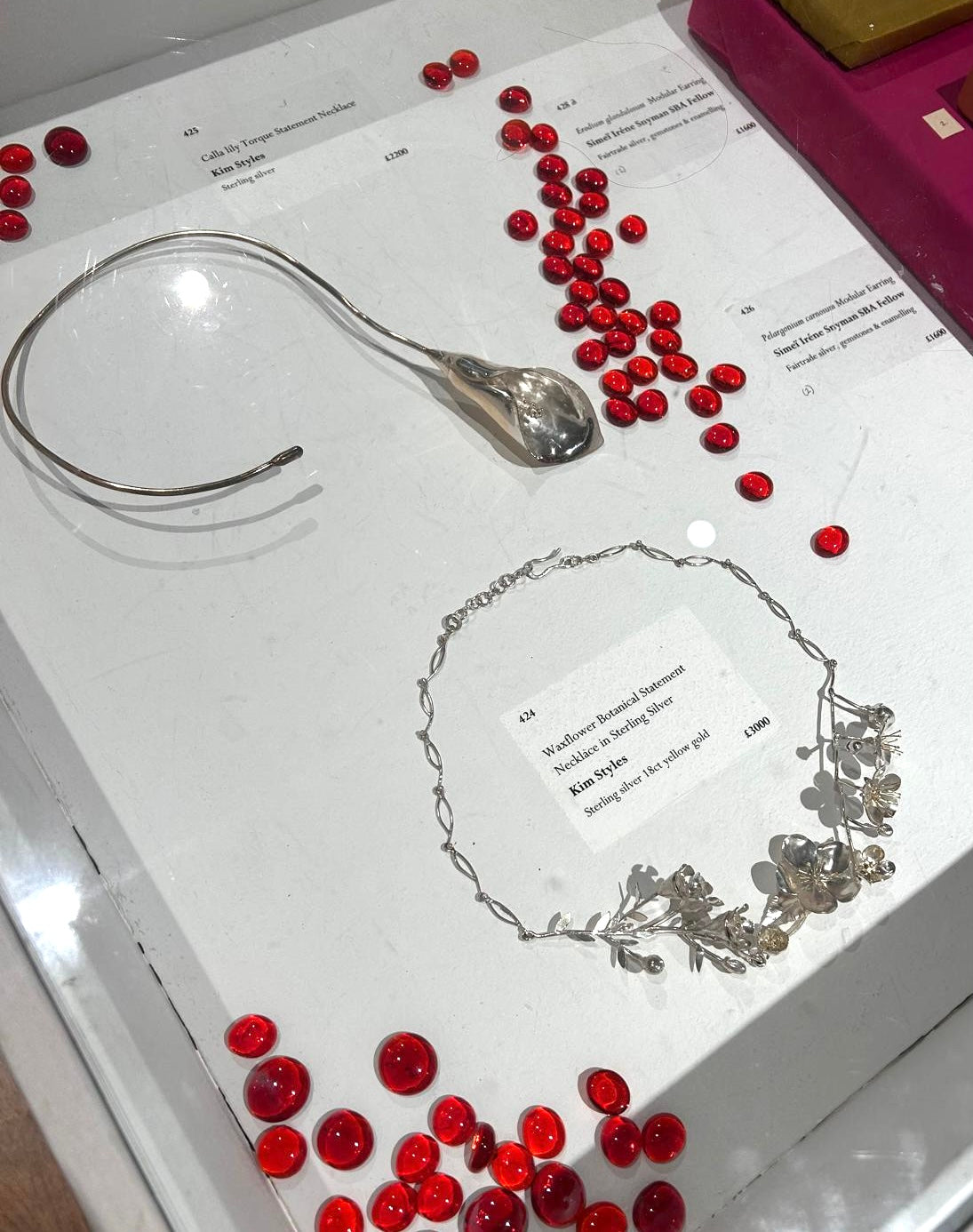 Kim Styles exhibiting at Plantae 25 at Mall Galleries London, cala lily hand forged sterling silver torque necklace and Waxflower Apple blossom hand forged sterling silver and 18ct gold botanical necklace