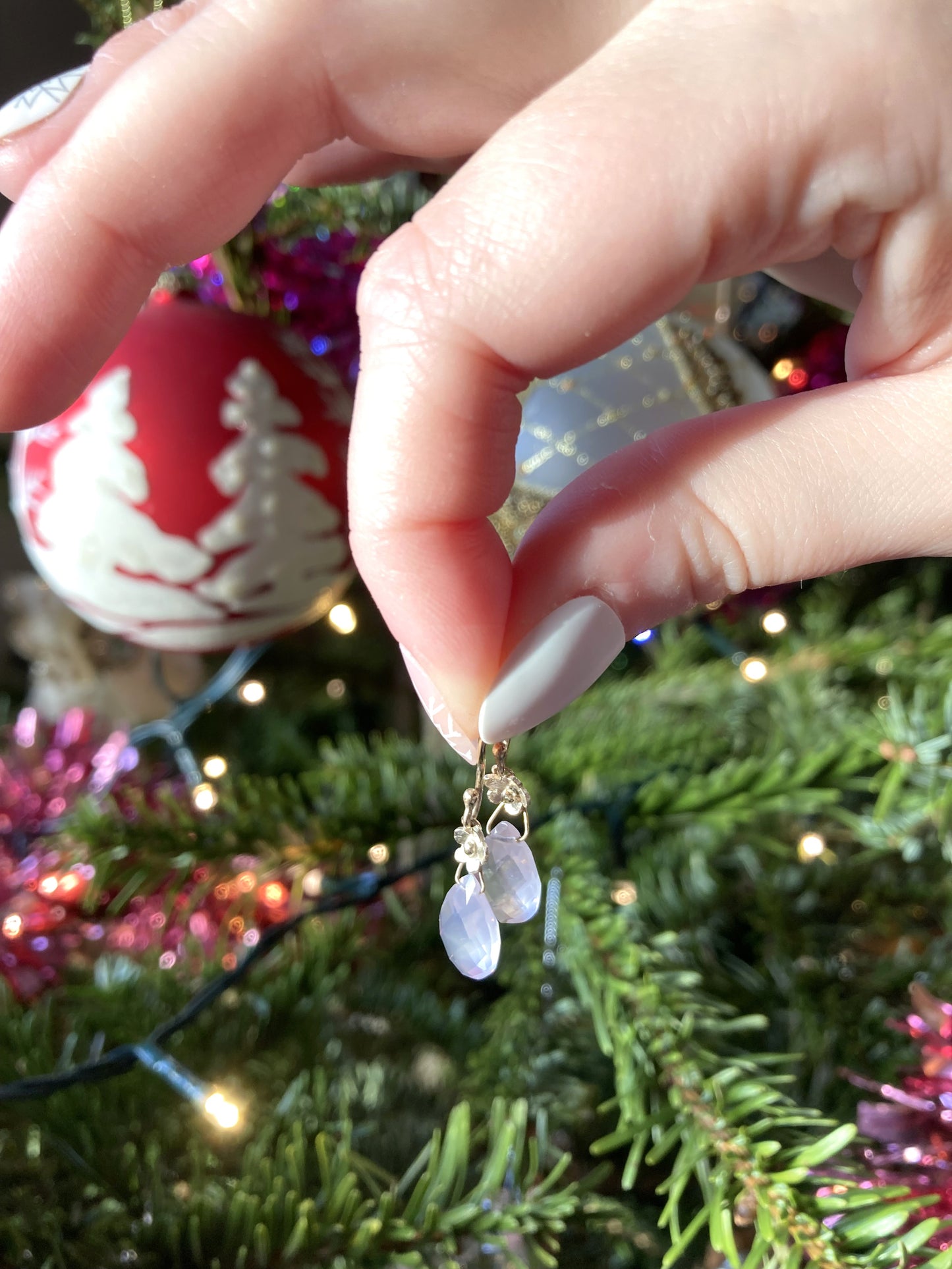 pear shape rose quartz gold floral drop earrings with Christmas tree background