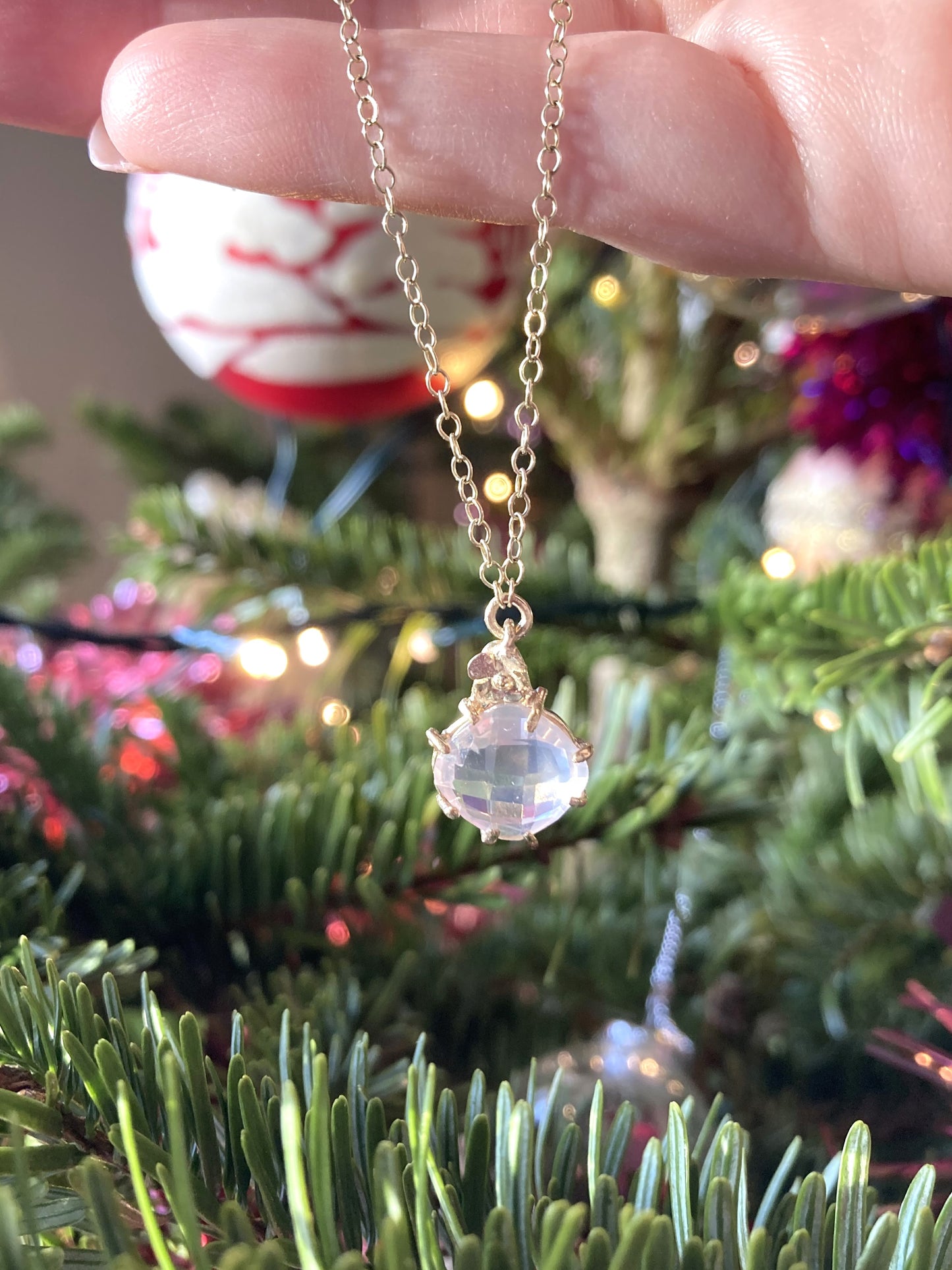gold rose quartz pendant with Christmas tree background