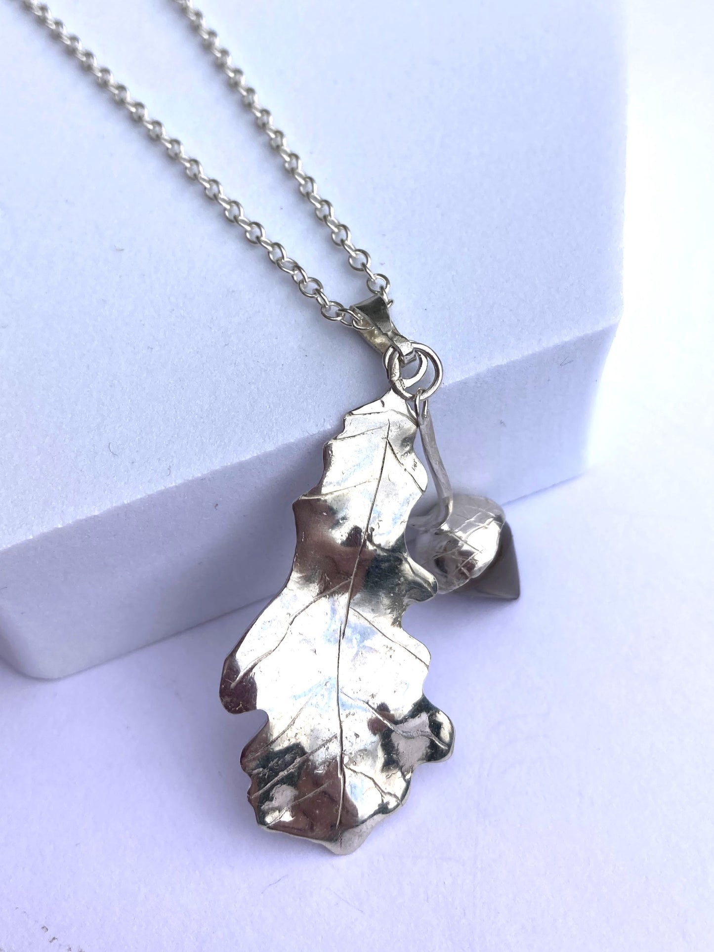 nature inspired oak and acorn handmade pendant on grey background