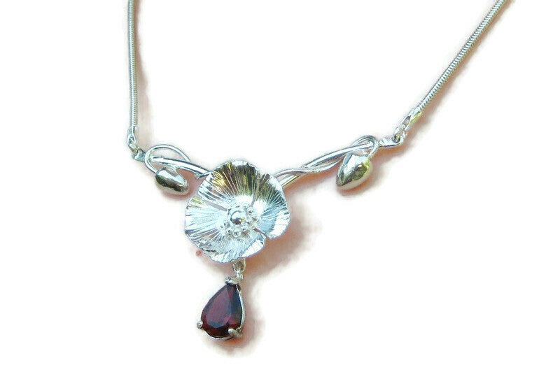 poppy and garnet textured necklace on white background