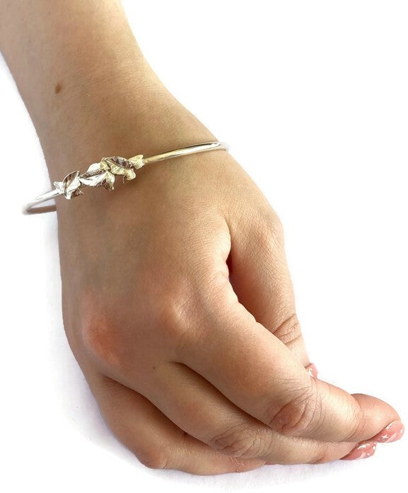 trilogy three ivy leaves bangle on hand, with white background