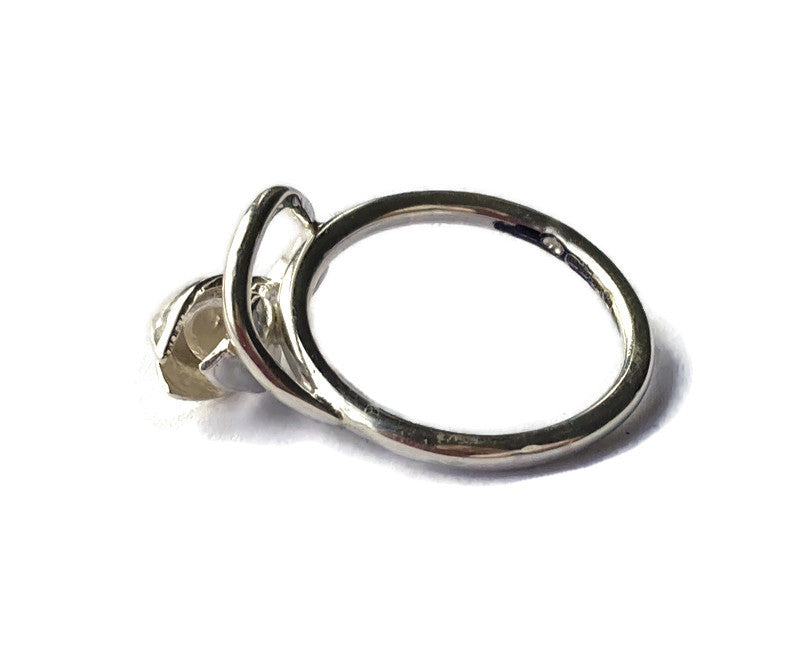 side view of silver snowdrop ring, on white background