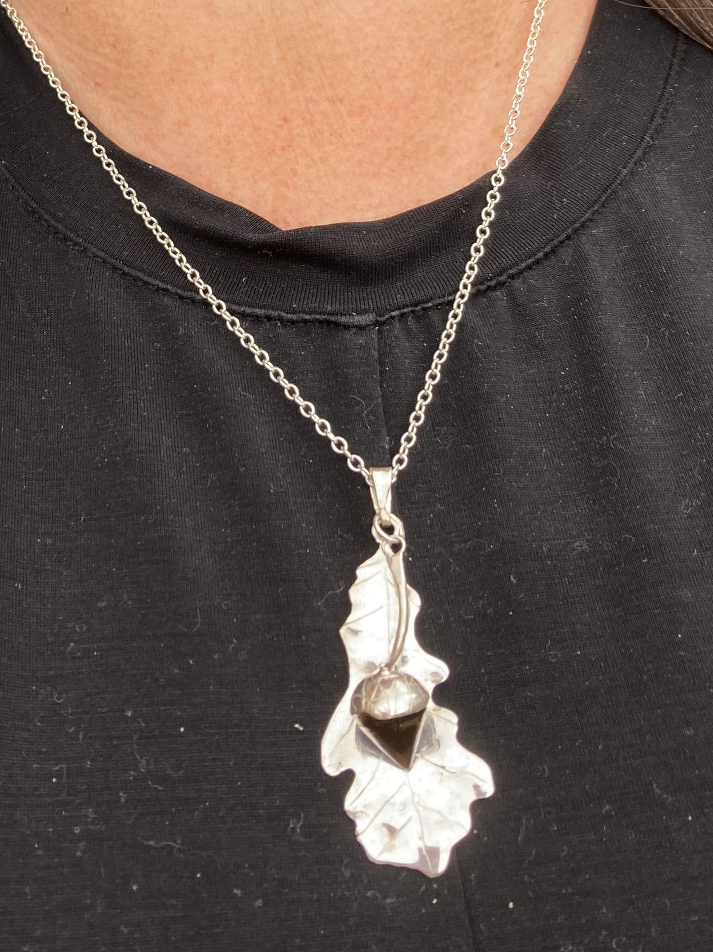 silver Oak and gemstone acorn pendant on black t-shirt