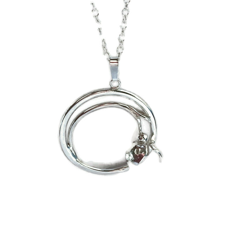 silver circle pendant with curling snowdrop, on white background