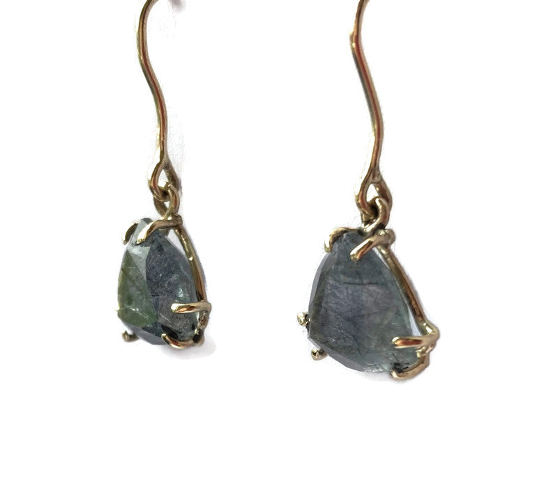gold prong drop earrings set with triangle rutilated quartz ,on white background