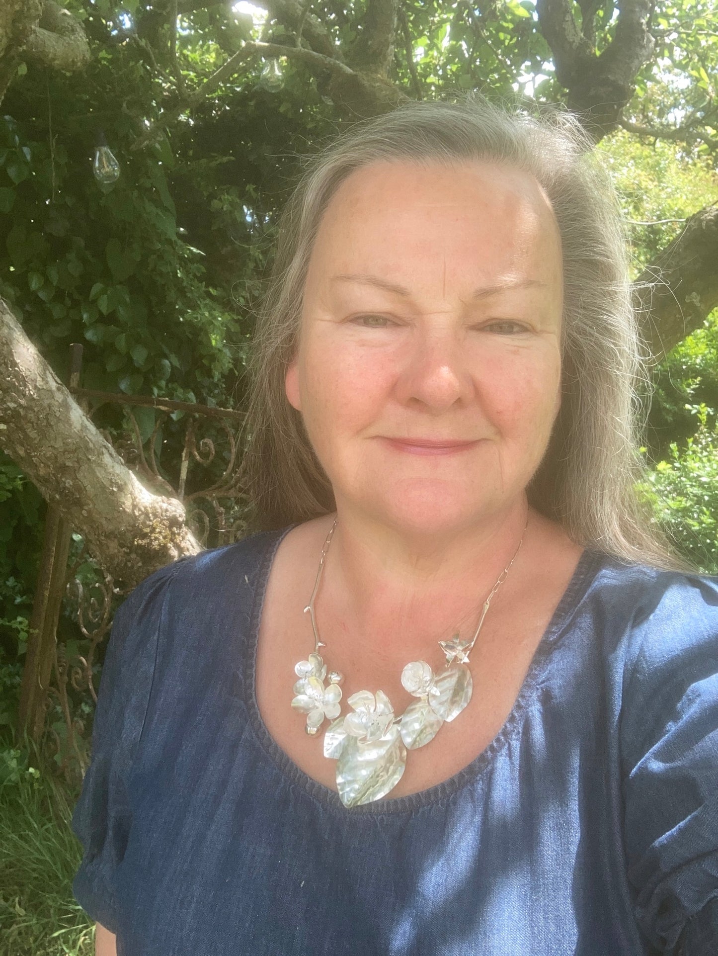 hand forged sterling silver spring flowers botanical necklace, on goldsmith Kim Styles