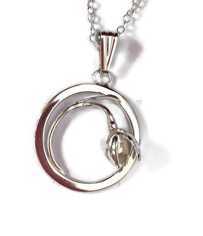 circle pendant with handmade snowdrop on white background