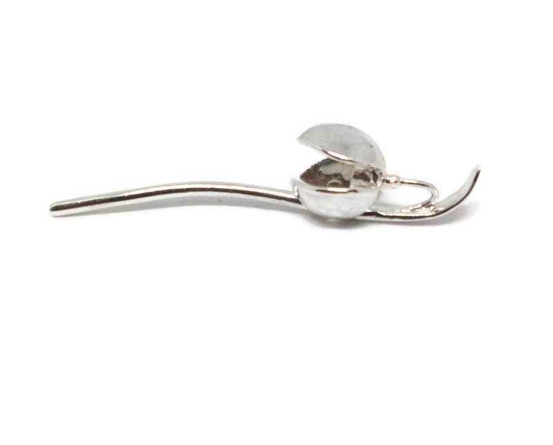 single silver snowdrop pendant on it's side, on white background