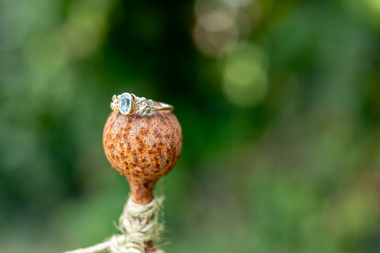 rusty ball with gold floral ring on the top