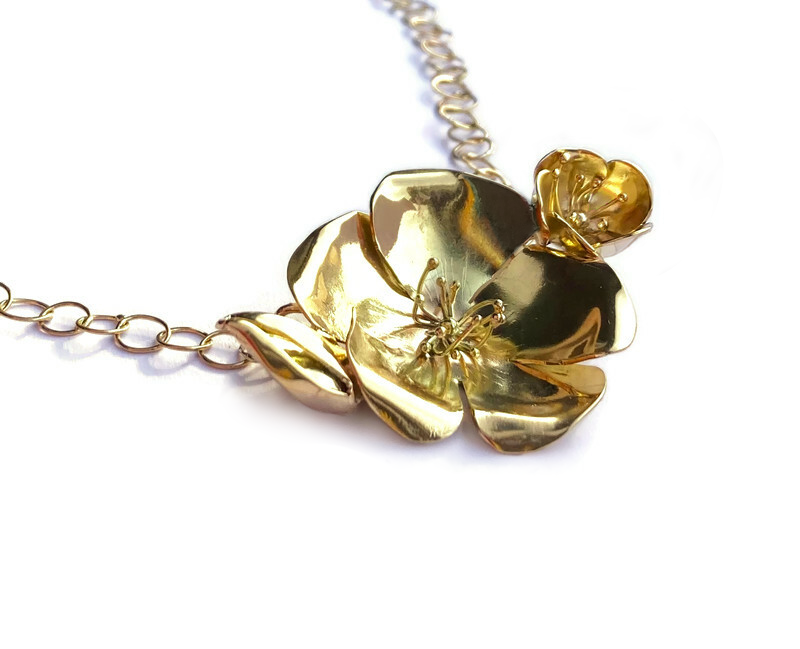 hand forged floral statement rose necklace in solid gold, on white background