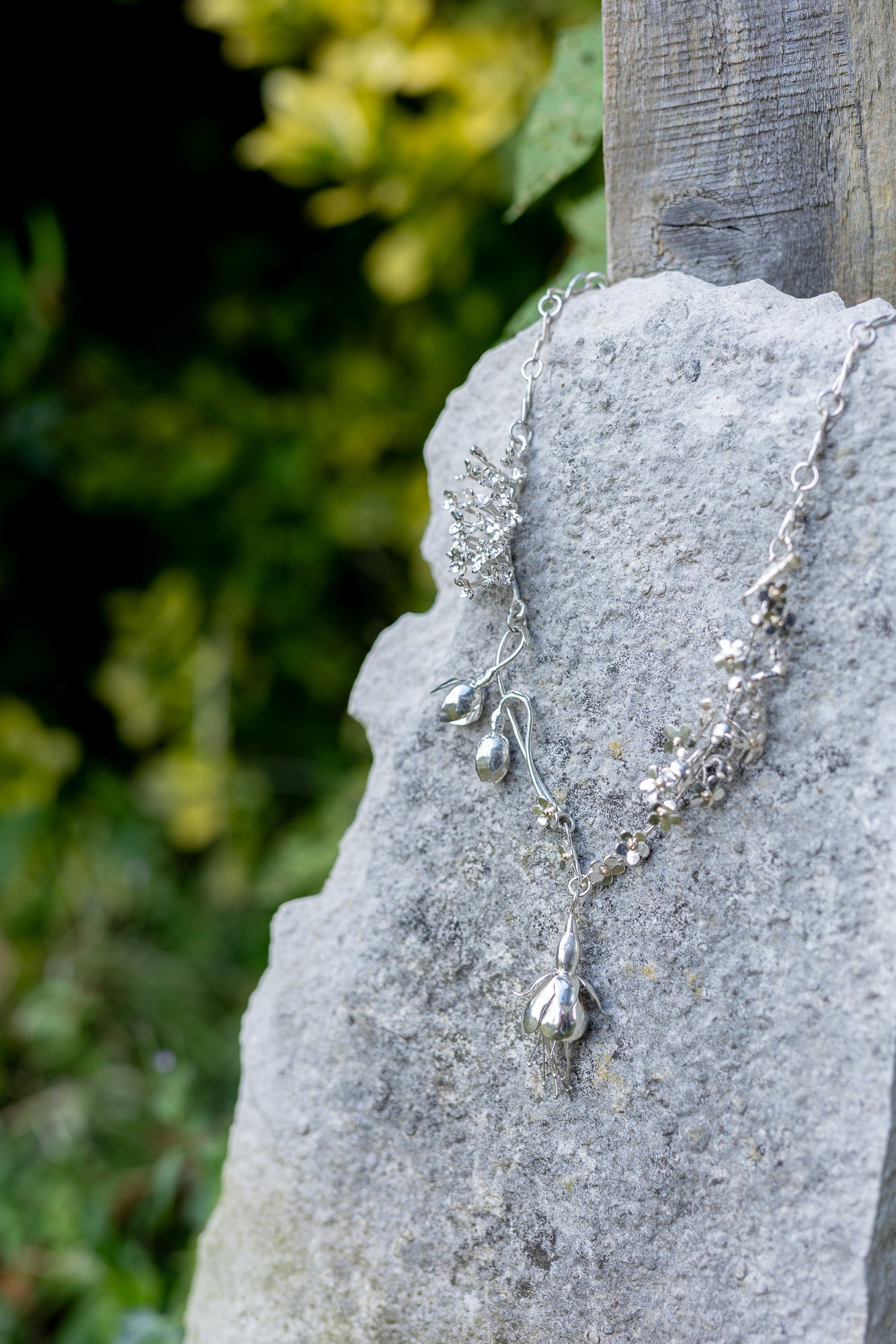 Very detailed life like floral necklace on stone slab