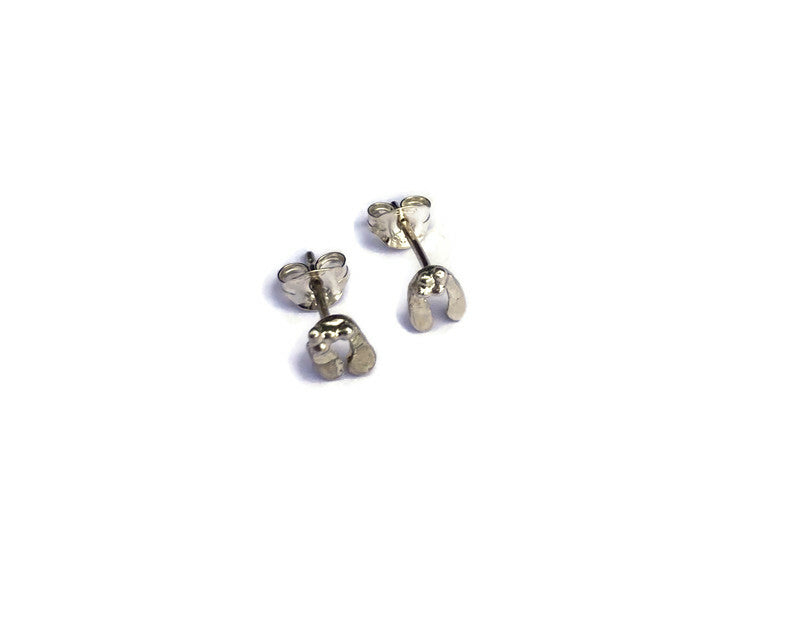 two small stud mistletoe earrings with scroll backs n white background