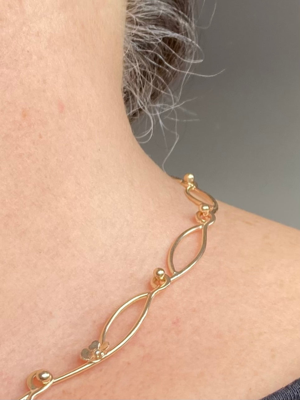 large link gold chain on ladies neck
