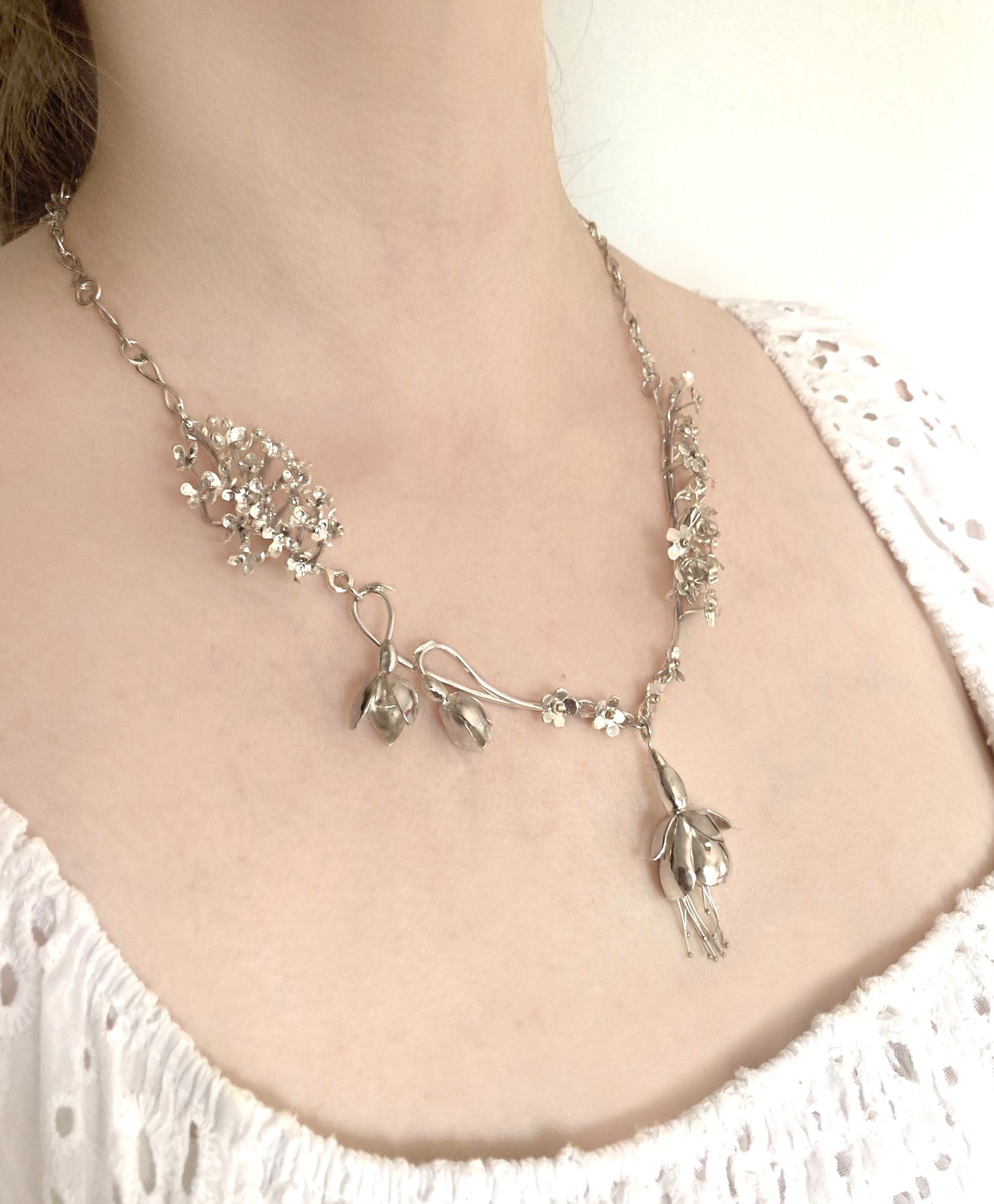 Sterling silver handmade botanical floral necklace on woman's neck