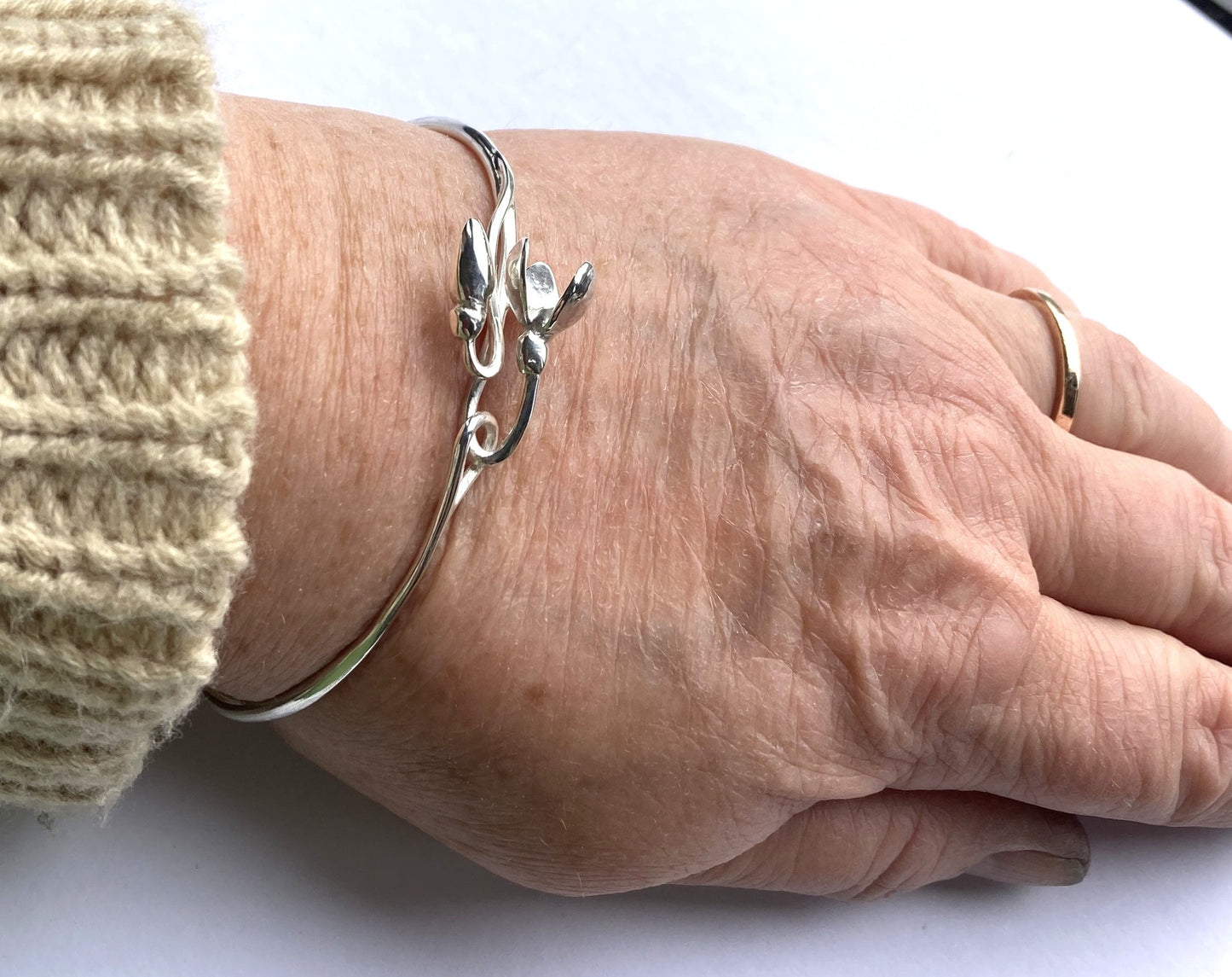 Botanical 3D snowdrop Silver bracelet on a wrist with a white background