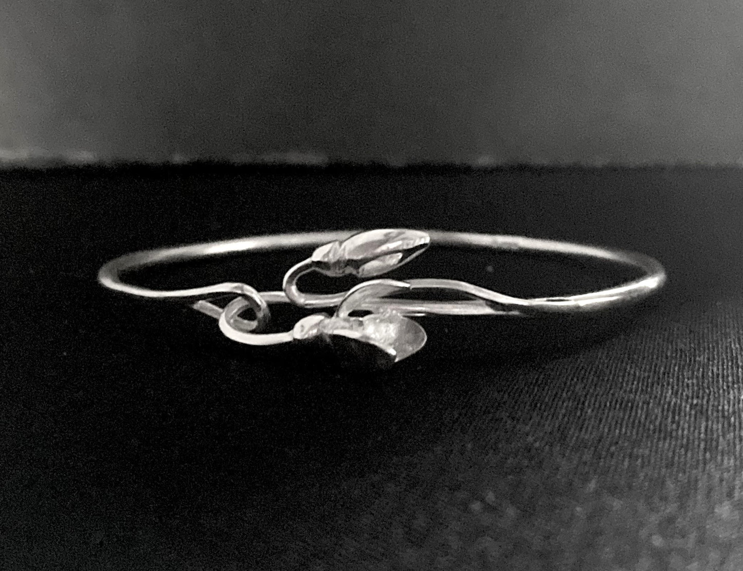 Handmade Silver bracelet with 3D floral snowdrop design by Kim Styles Jewellery on a black background