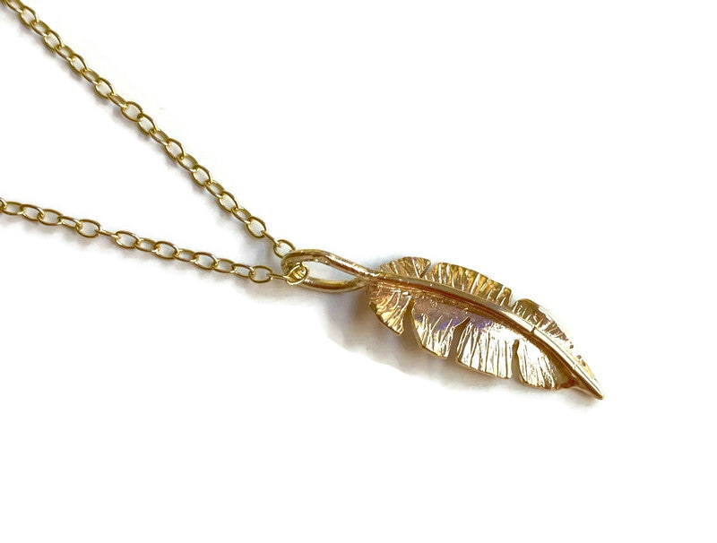 Yellow gold feather pendant with hand hammered texture and yellow gold chain