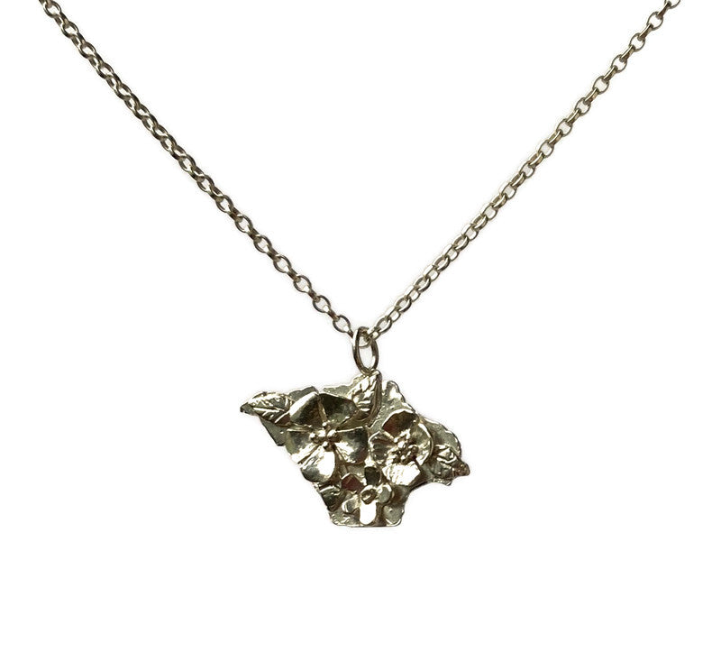silver silhouette pendant of Isle of Wight with flowers in relief, on white background