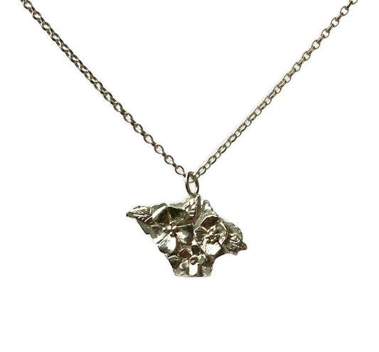 silver silhouette pendant of Isle of Wight with flowers in relief, on white background