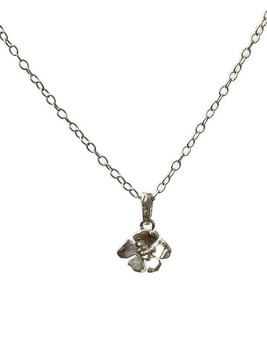 small wild rose flower pendant and chain on white background