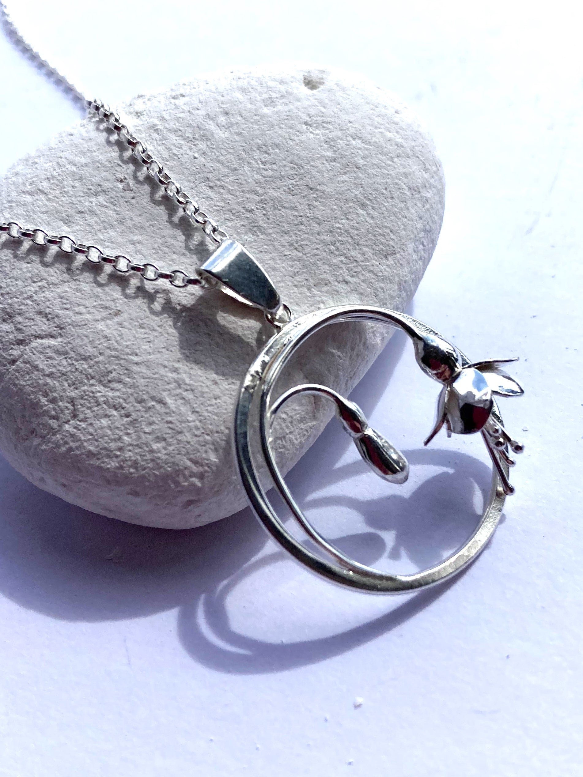 handmade silver botanical circle pendant with 3D fuchsia flowers