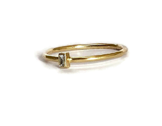 diamond baguette gold solitaire ring, simple engagement ring, on white background