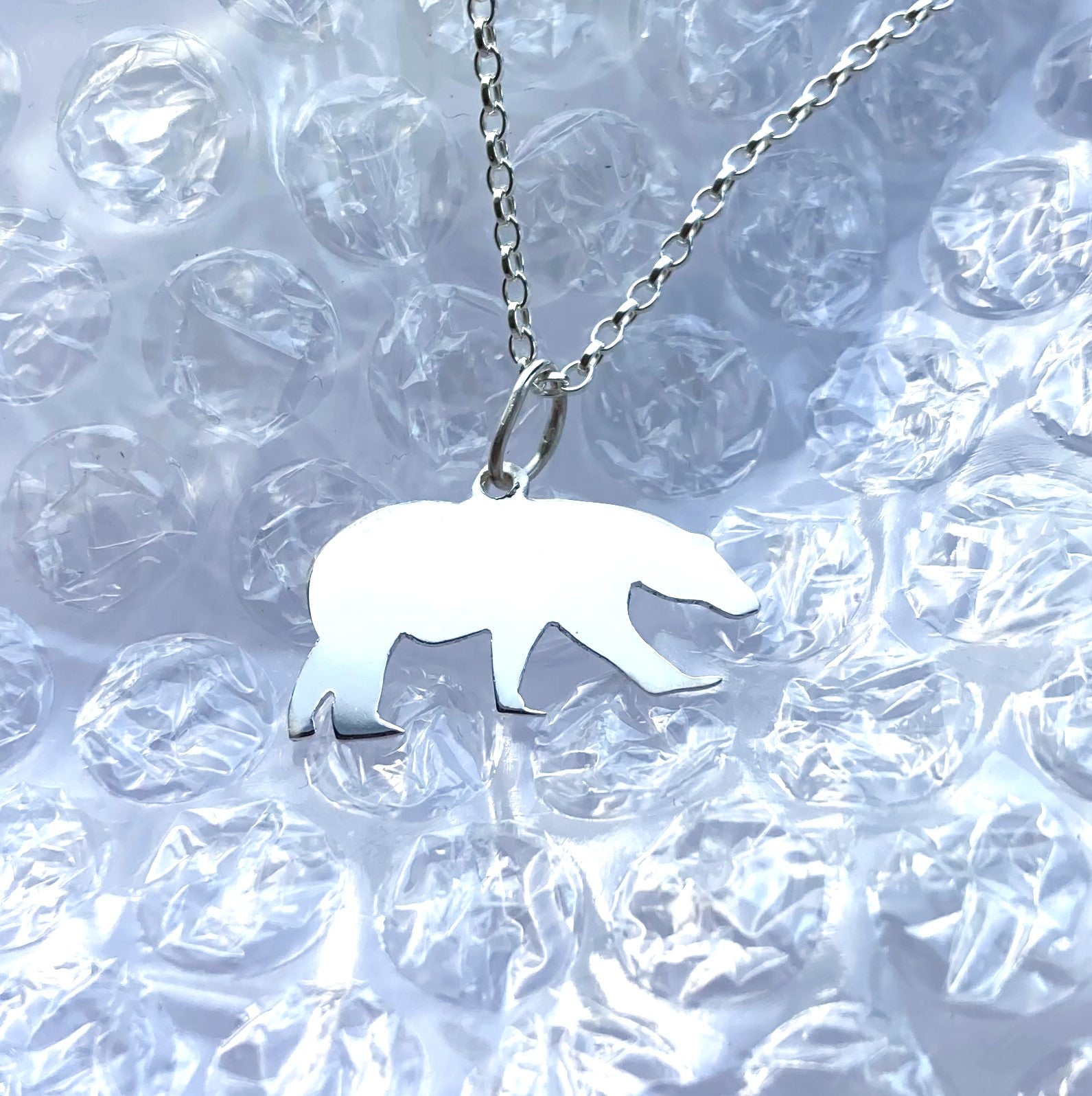 silver polar bear silhouette pendant on bubble wrap