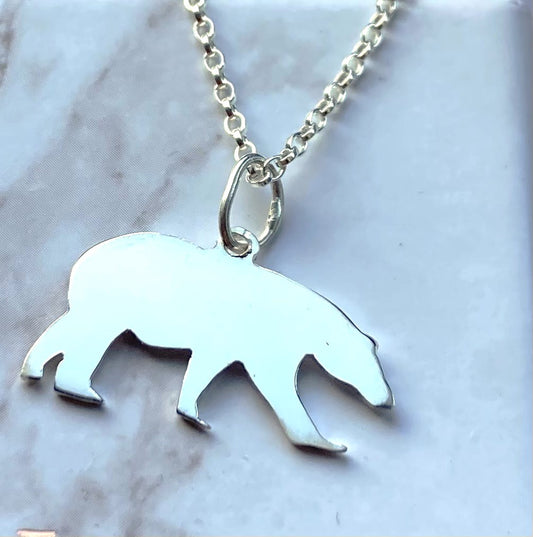 silver polar bear silhouette pendant on grey background