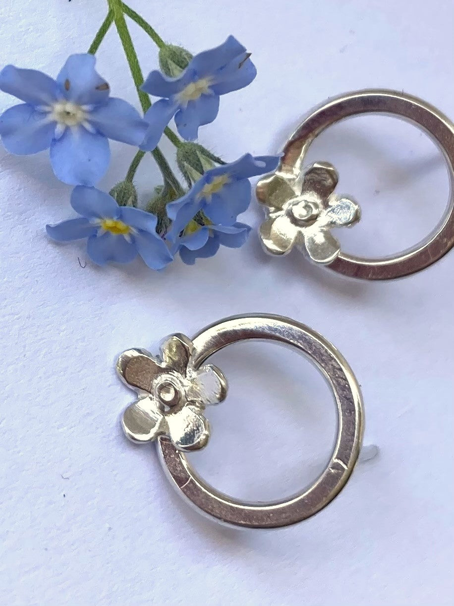 blue forget-me-not flowers with silver hoop earrings with flower detail