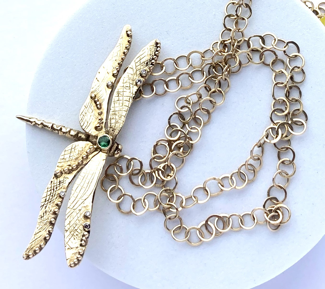 flamboyant gold dragonfly pendant on handmade chain, LGBTQ, grey background