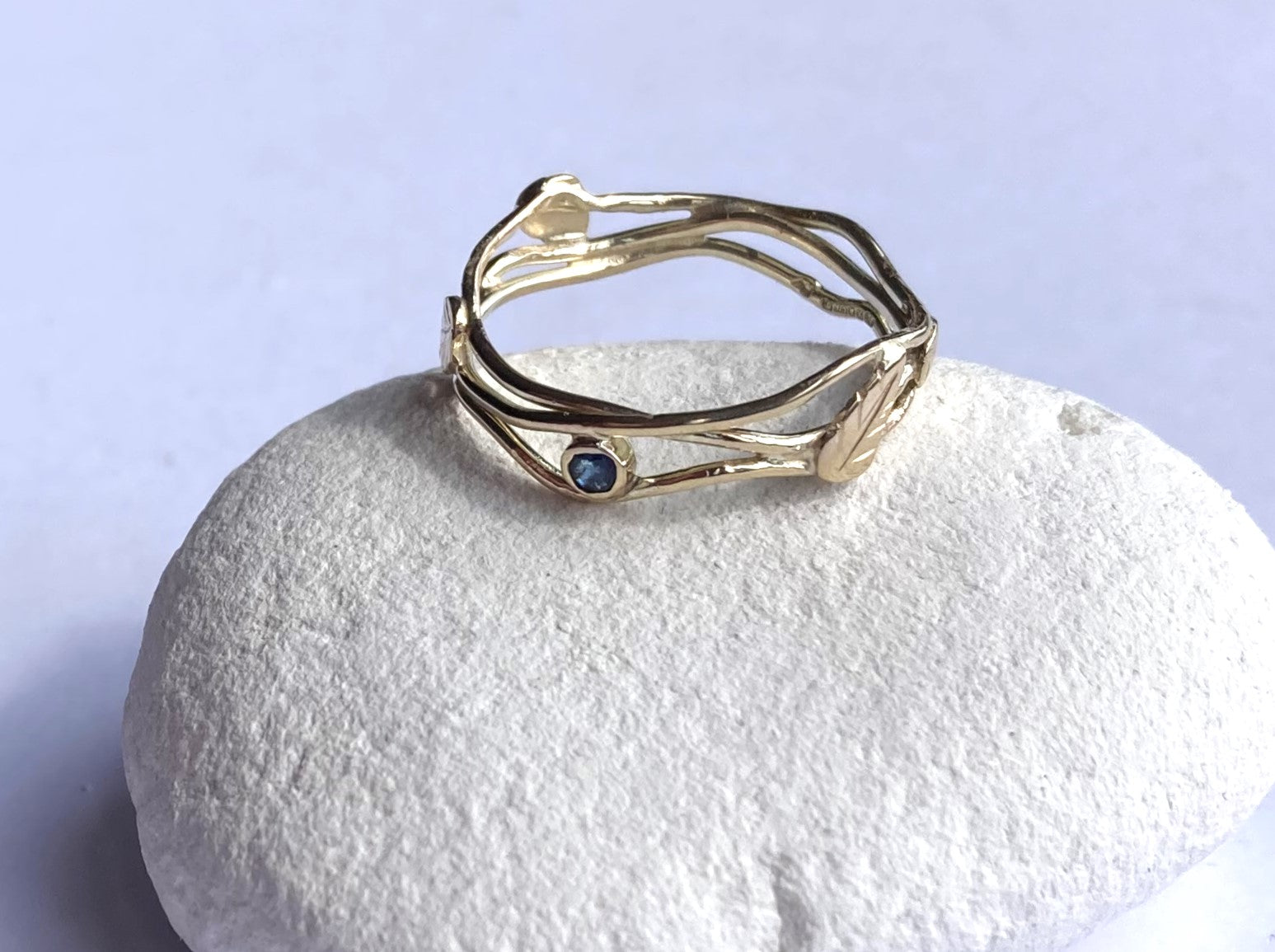 dainty gold  crossed wire ring with sapphire 