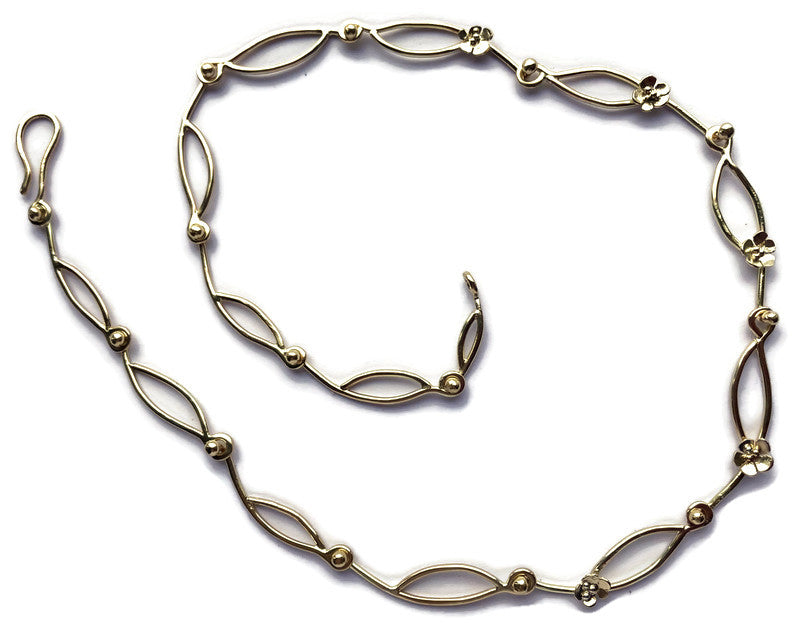 floral large link gold chain in a spiral shape, on white background