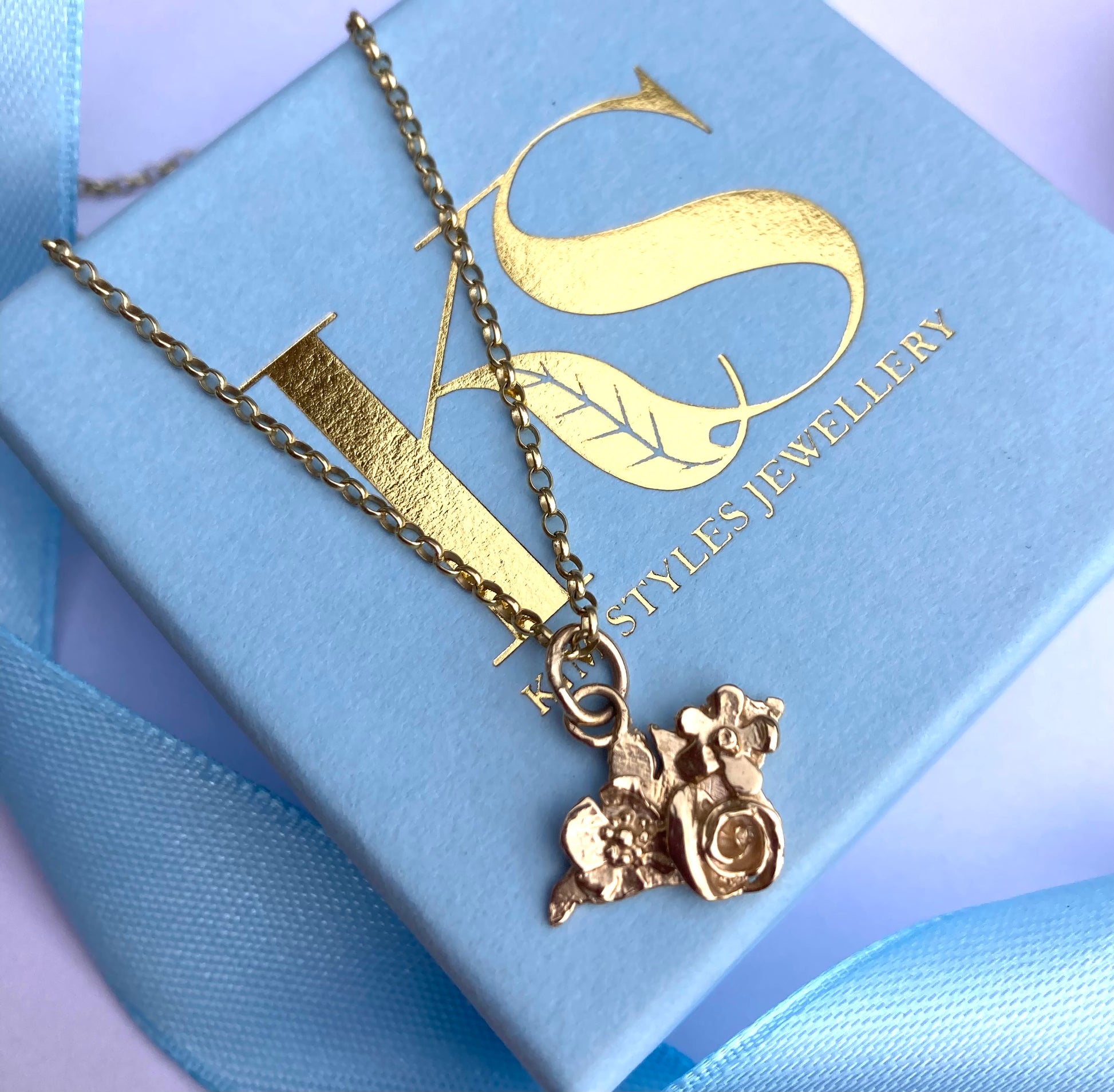 gold floral Isle of Wight silhouette pendant and chain on Kim Styles Jewellery logo blue box