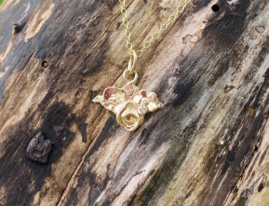 gold floral Isle of Wight pendant Silhouette on tree bark