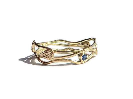dainty entwined gold wire ring with leaves and sapphire