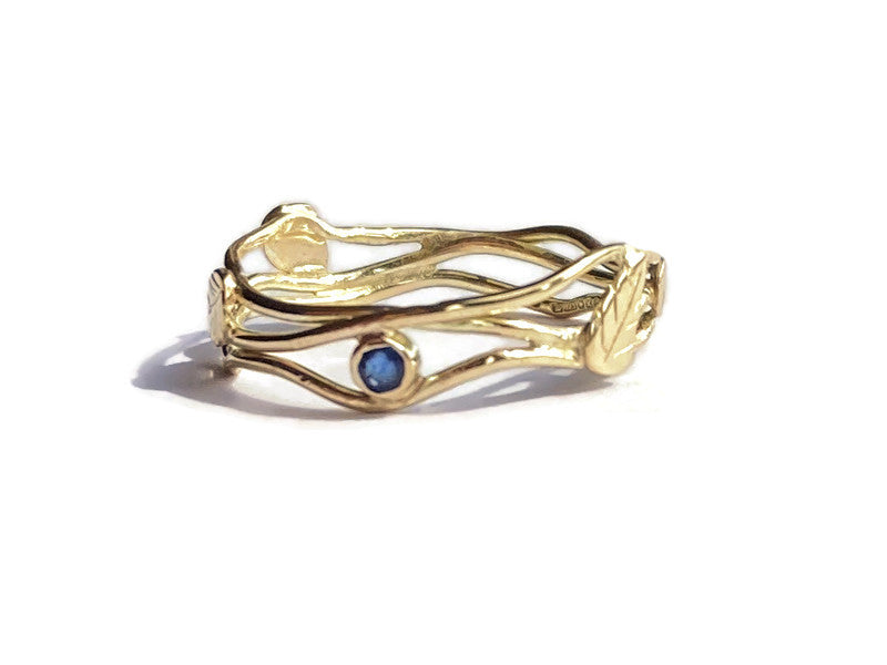 gold sapphire ring with leaf detail