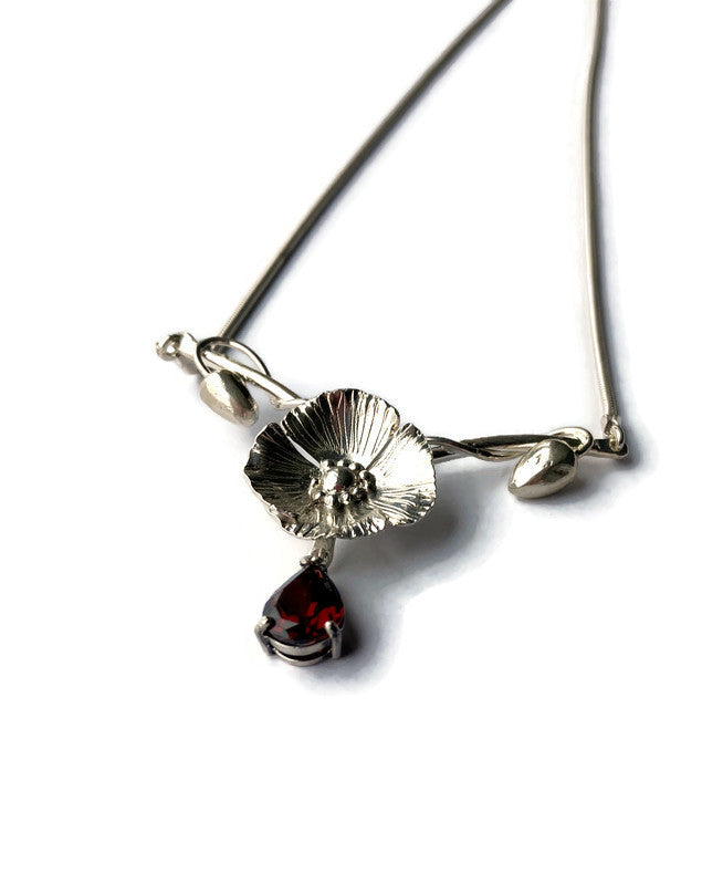 art nouveau style handmade poppy necklace with red garnet drop, on white background
