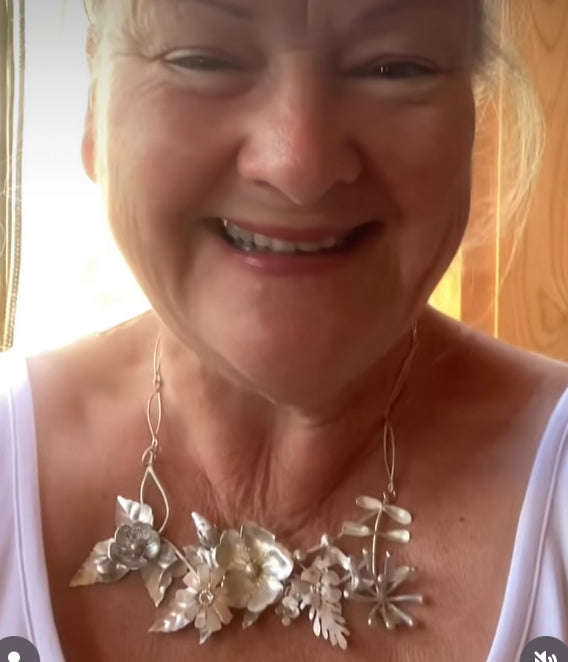 wildflower hedgerow necklace being worn on smiling woman
