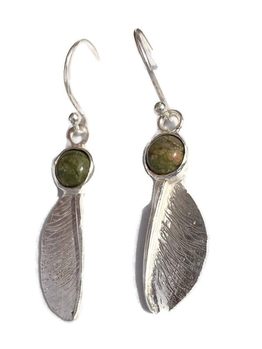 Pair of sterling silver textured sycamore seed hook earrings by Kim Styles Jewellery set with round cabochon green agates, on white background