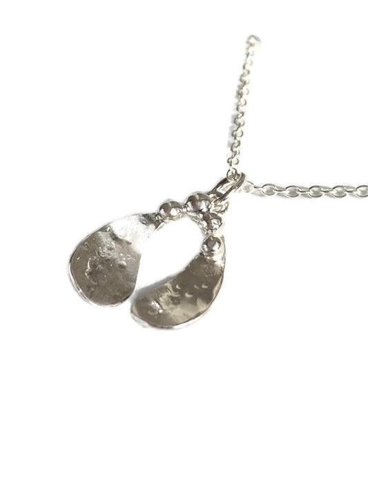 A textured 
silver mistletoe leaf pendant necklace shown on a plain white background.