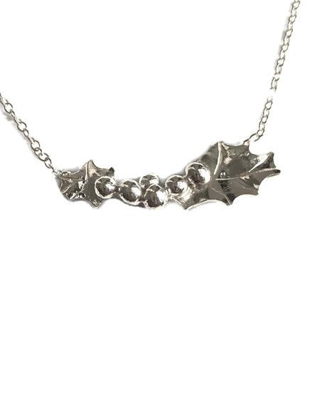 A silver holly leaf necklace  by Kim Styles Jewellery, shown against a plain white background.