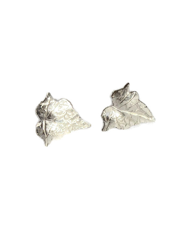 A pair of silver ivy leaf stud earrings on a plain white background.