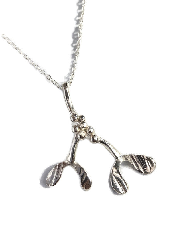 A sterling silver mistletoe pendant necklace by Kim Styles |Jewellery, on a delicate silver chain, photographed against a clean white background.