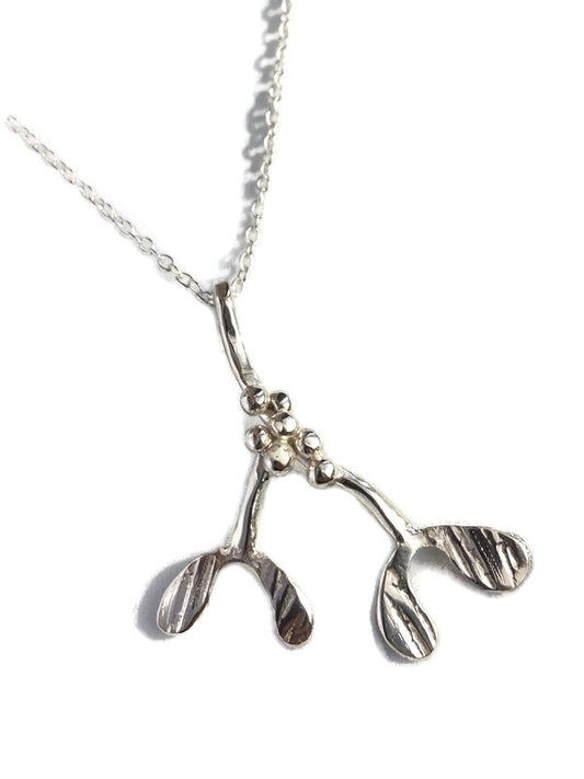 A sterling silver mistletoe pendant necklace by Kim Styles |Jewellery, on a delicate silver chain, photographed against a clean white background.
